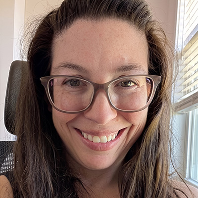 Professional headshot of Kristen Aguilar, MA BCBA delivering natural-environment teaching and parent coaching in Virginia.